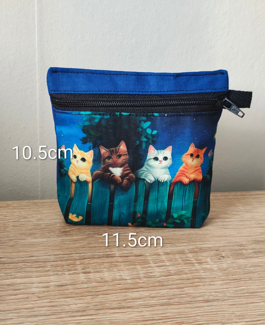 Small pouch with cat design on a wooden surface