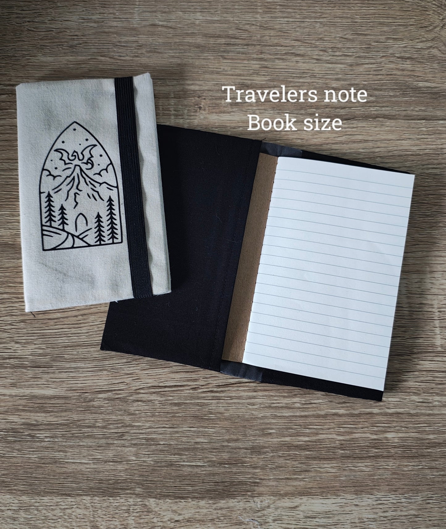 Travelers notebook with a black and white design on a wooden surface