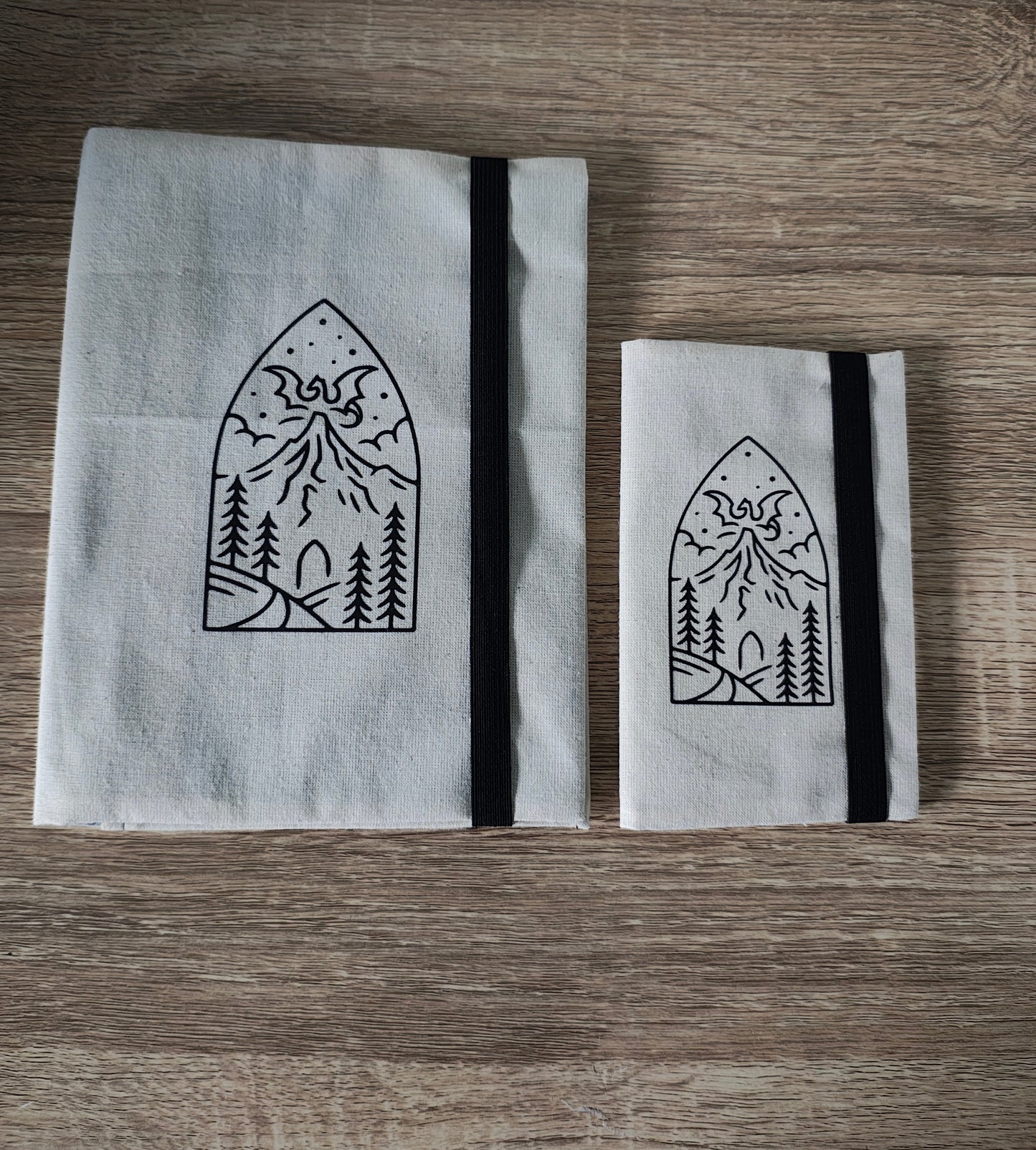 Dragon mountain cream note book covers on a wooden surface