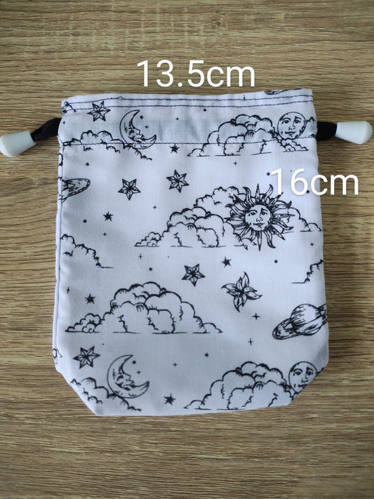 Drawstring bag with celestial pattern on a wooden surface, showing measurements.