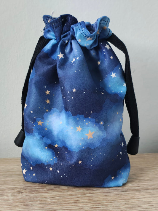 Blue drawstring bag with star pattern on a light gray background
